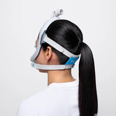 Woman wearing the F30i mask looking away to show the back of the mask.