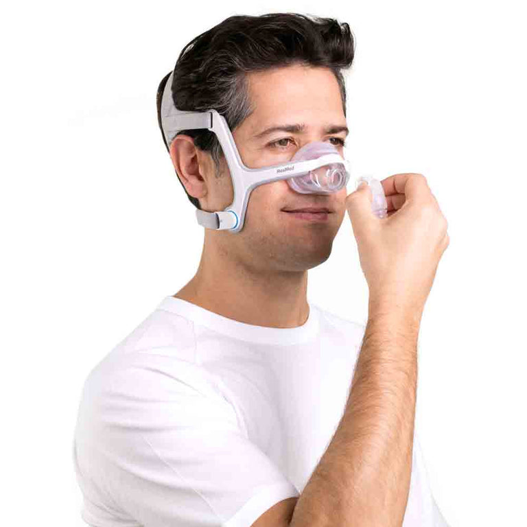 Man adjusting his  ResMed AirFit N20 Nasal Mask
