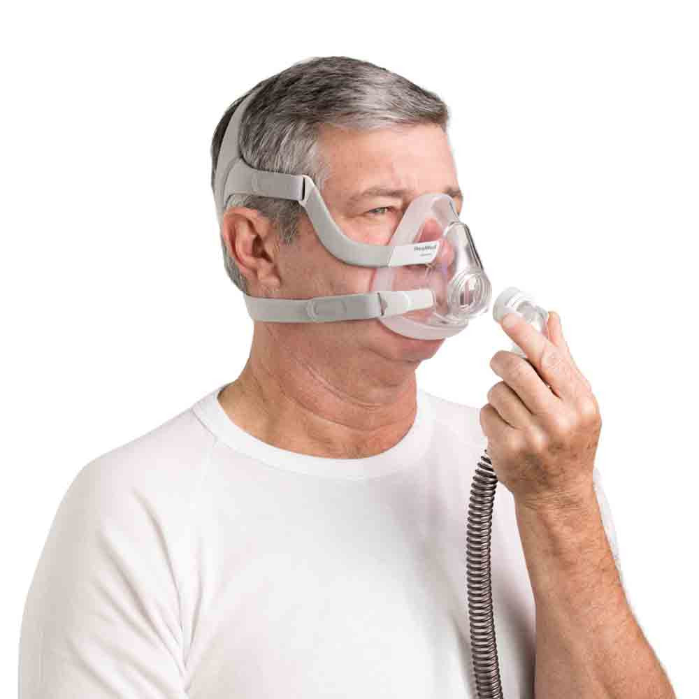 Man using ResMed AirFit F20 with CPAP tubing