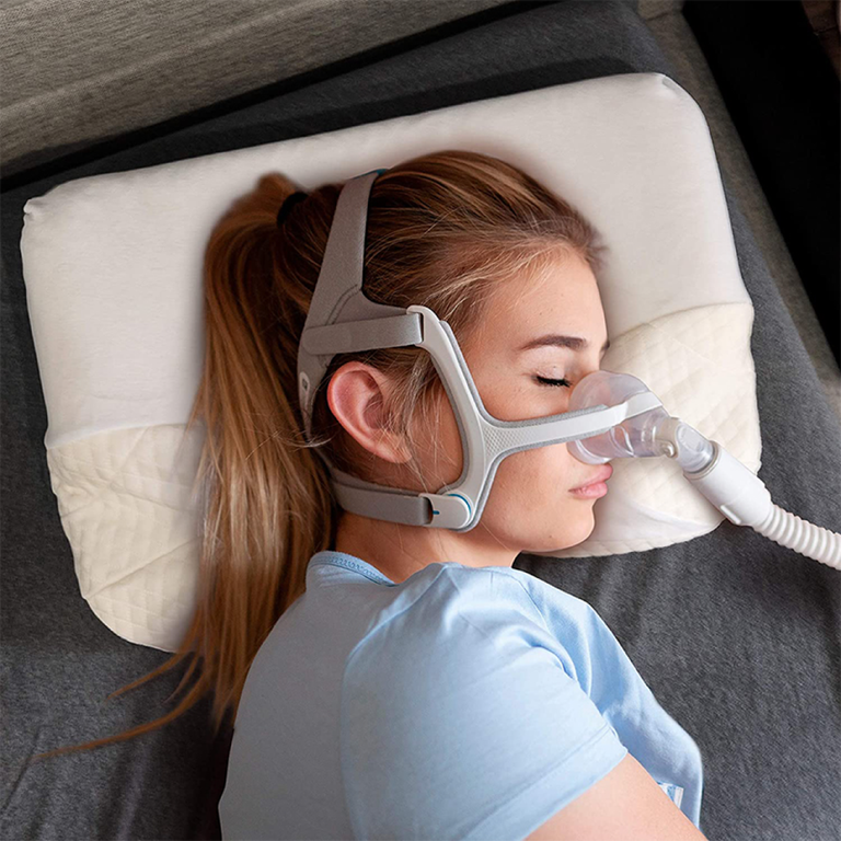 Person using CPAP Mask on CPAP Pillow