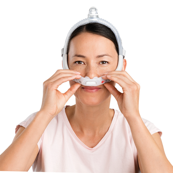 Woman adjusting ResMed AirFit P30i Pillows Mask