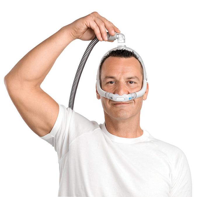 Man installing CPAP tubing on ResMed AirFit P30i Pillows Mask